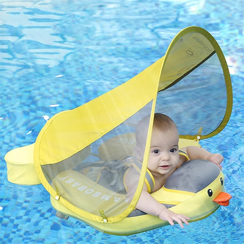 Infant in the Mambobaby Duck float practicing safe swimming in a luxury pool using the 40-degree horizontal position.