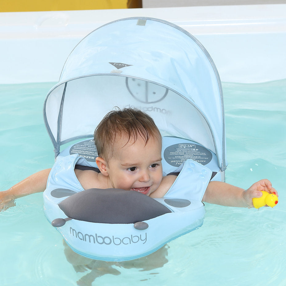 Toddler using the Mambobaby Ladybug shoulder float with UV canopy for safe, independent swimming discovery.