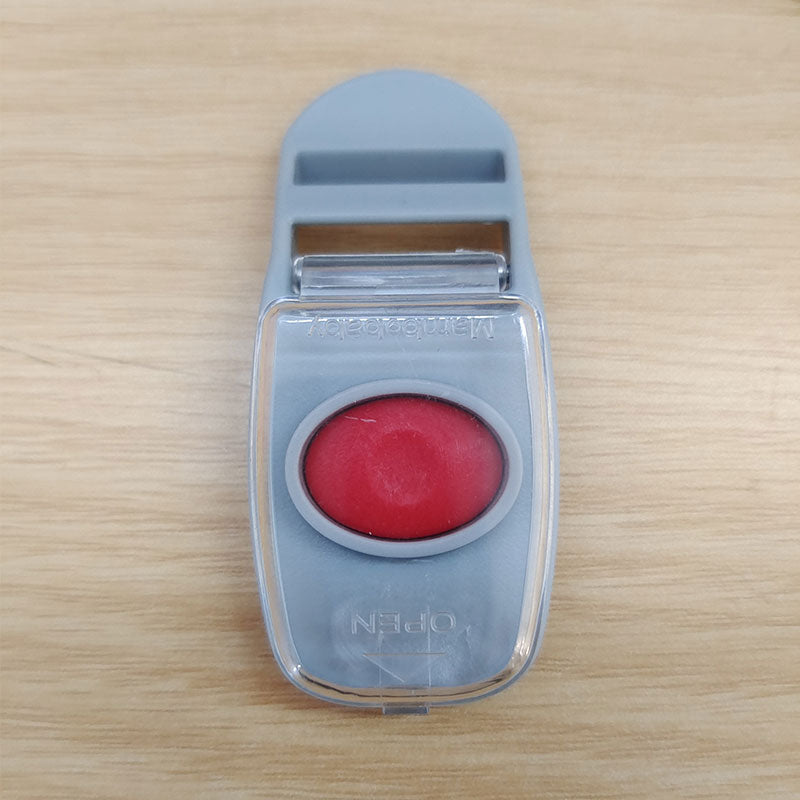 The quick-release unlock button of a Mambobaby™ float, designed for easy adult access while remaining secure from babies.