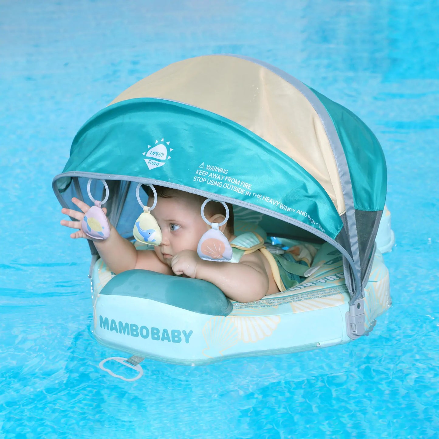 Happy baby swimming in Mambobaby Seashell Float. The only waterproof leather non-inflatable safety swim trainer for infants.